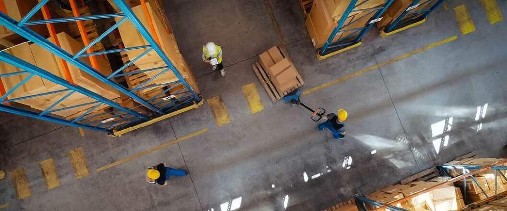 An overhead view of workers on a warehouse floor.